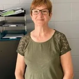 Moira in the office wearing a green blouse Moira in the office wearing a green blouse